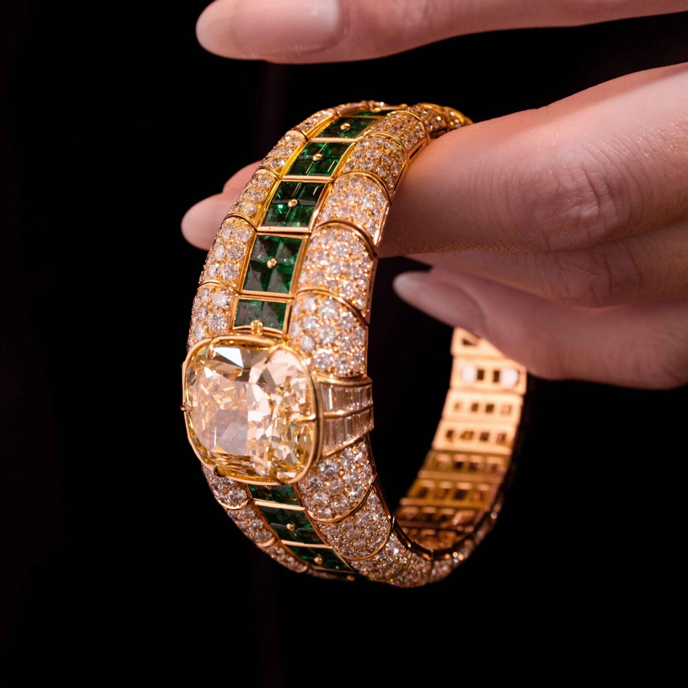 Bulgari Yellow Gold Diamond and Emerald Bangle on Hand in hand