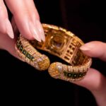 Bulgari Yellow Gold Diamond and Emerald Bangle in Hands back View