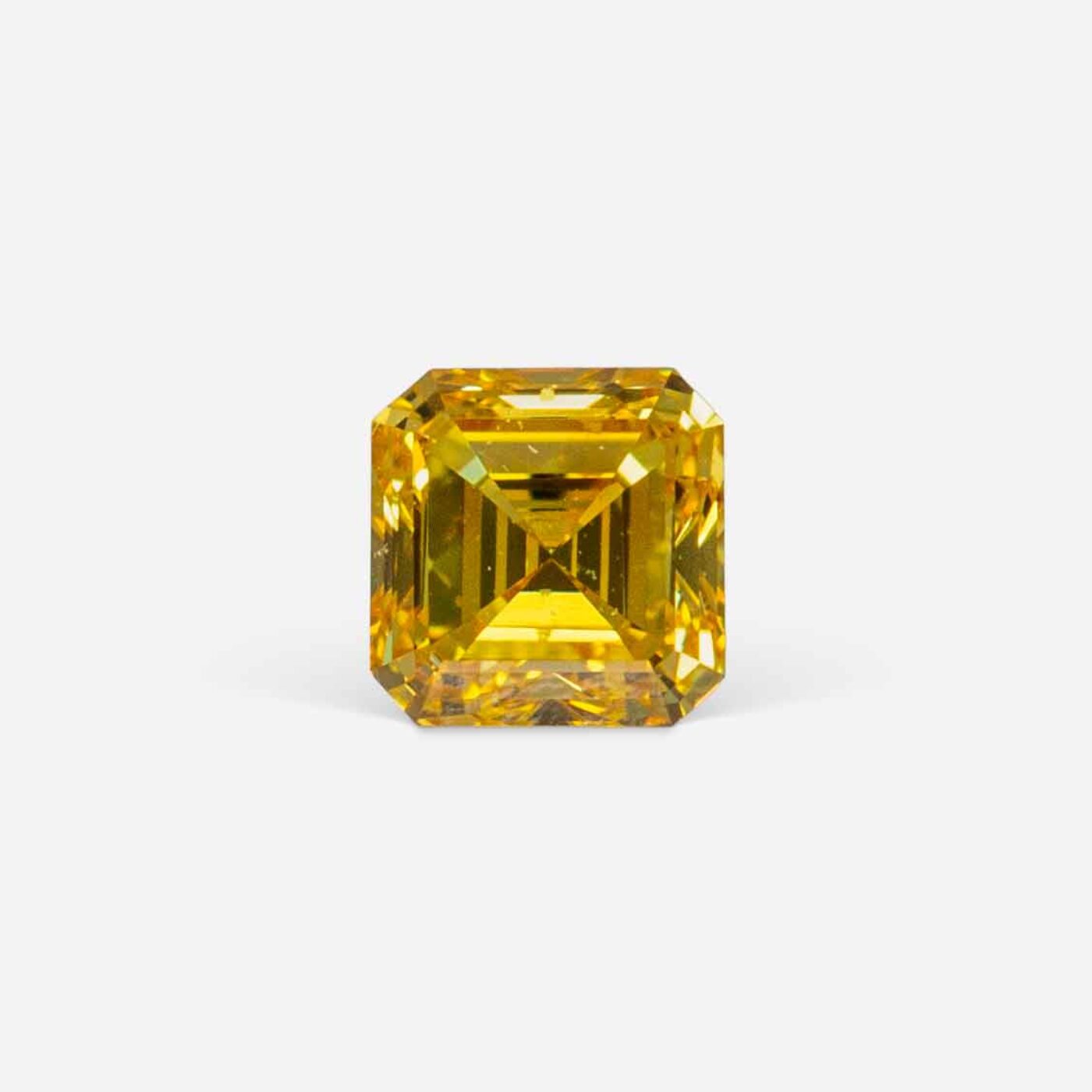 0.20 Ct Fancy Vivid Orangy Yellow Square Emerald Cut Natural Diamond on Gray Background