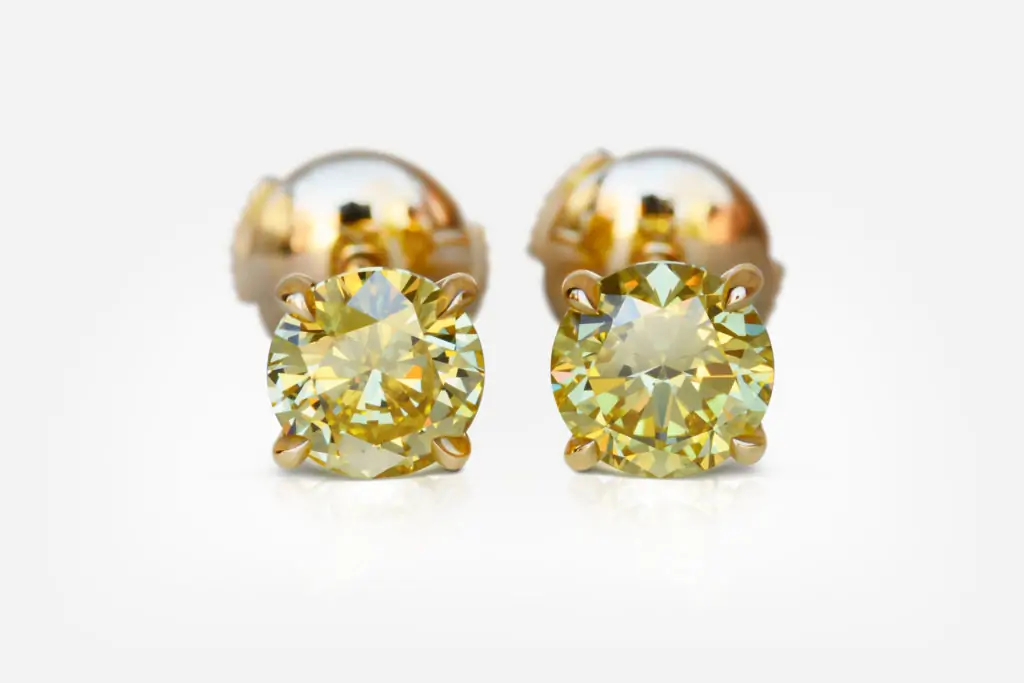 1.01 and 1.13 carat Pair of Fancy Intense Yellow VS1 / VS2 Round Shape Diamonds studs GIA